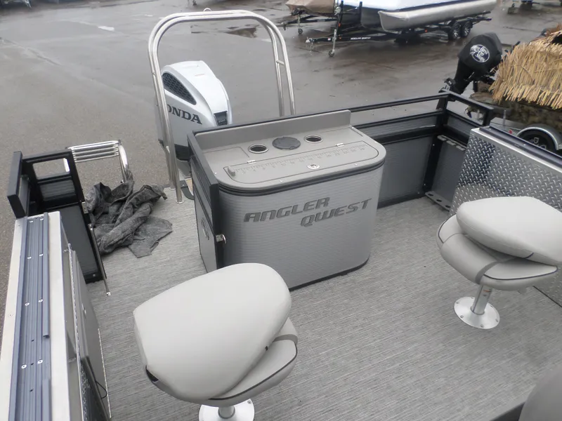 Slide: The Image of 2024 Angler Quest 8522/24 Pro Fish N Cruise boat interior with seating and Honda motor. - 6
