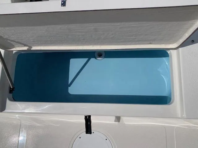 Slide: The Image of 2024 Bulls Bay 2200 boat storage compartment with open lid, showcasing interior space. - 11
