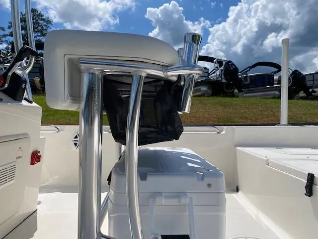 Slide: The Image of 2024 Bulls Bay 2200 boat interior with seating and storage, under a partly cloudy sky. - 13