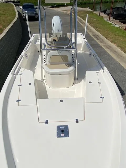 Slide: The Image of 2024 Bulls Bay 2200 boat, white deck, center console, parked on a road. - 3