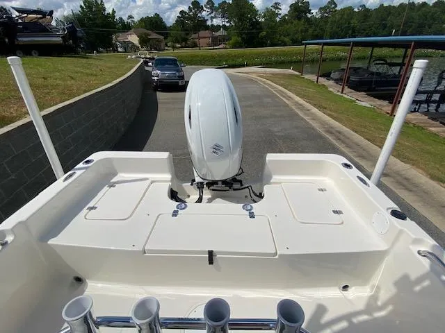 Slide: The Image of 2024 Bulls Bay 2200 boat with Suzuki outboard motor, parked near a lake. - 6