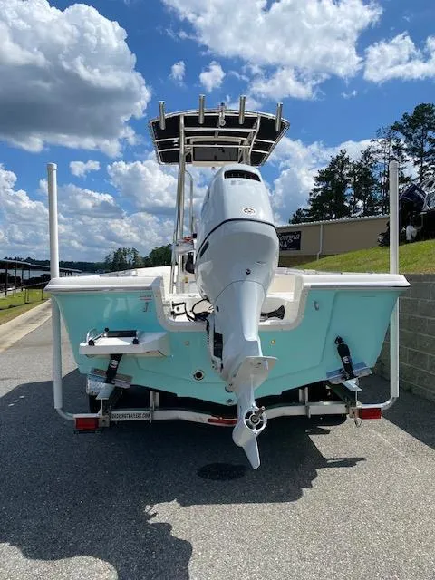 Slide: The Image of 2024 Bulls Bay 2200 boat with outboard motor, parked on a sunny day. - 7