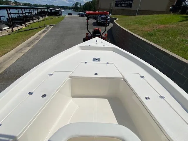 Slide: The Image of 2024 Bulls Bay 2200 boat at marina, showcasing spacious deck and storage compartments. - 8