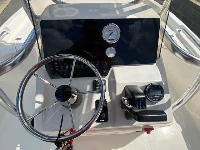 Slide: The Image of 2024 Bulls Bay 2200 boat dashboard with steering wheel and control panel. - 9