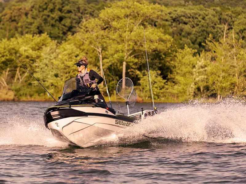 Slide: The Image of 2025 Sea-Doo FishPro Apex 300 jet ski on a lake, with fishing gear. - 16