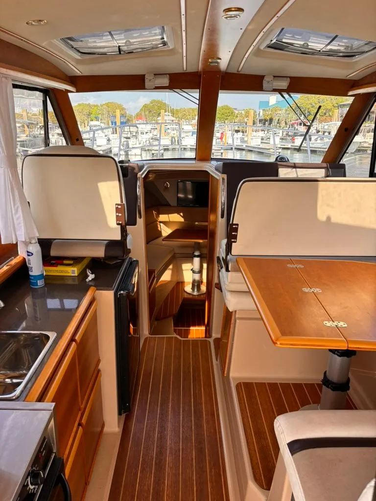 Slide: The Image of Interior of a 2016 Cutwater 28 LE boat with wood accents and seating. - 16