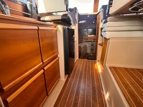 Slide: The Image of Interior of 2016 Cutwater 28 LE boat with wooden cabinetry and flooring. - 17