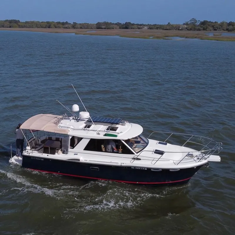 Slide: The Image of 2016 Cutwater 28 LE boat cruising on a calm river under clear skies. - 2