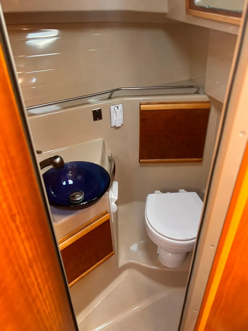 Slide: The Image of 2016 Cutwater 28 LE boat bathroom with blue sink and toilet. - 24