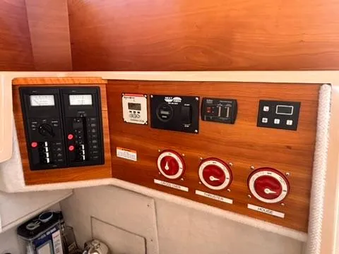 Slide: The Image of Control panel of a 2016 Cutwater 28 LE boat with various switches and gauges. - 27