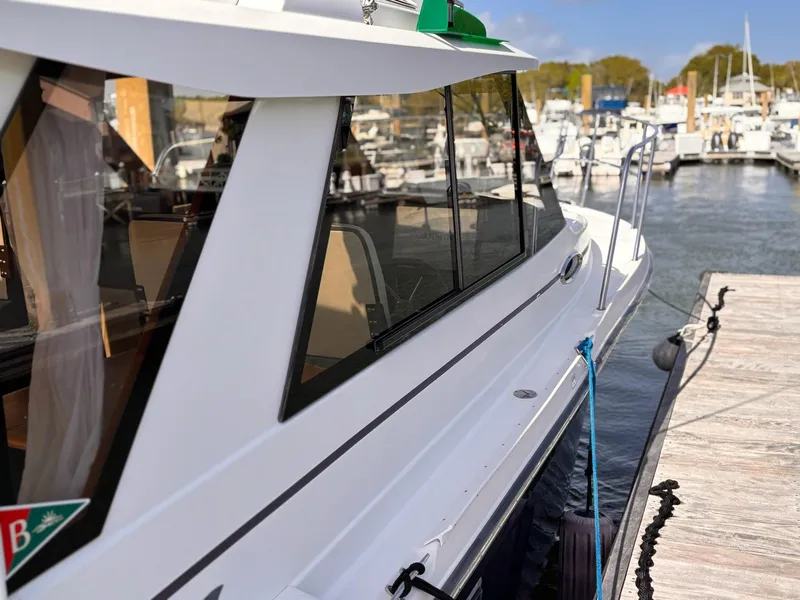 Slide: The Image of 2016 Cutwater 28 LE boat docked at marina, side view with clear windows. - 5