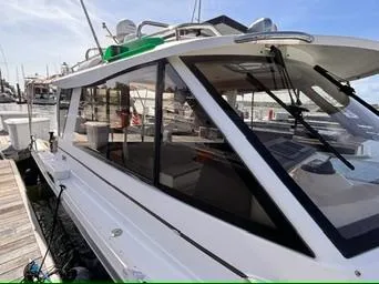 Slide: The Image of 2016 Cutwater 28 LE boat docked at marina, side view with windows and deck. - 6