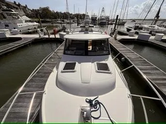 Slide: The Image of 2016 Cutwater 28 LE docked at a marina, surrounded by other boats. - 8