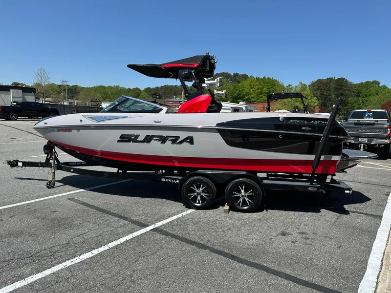 The Image of 2015 Supra SG400-550 boat on trailer in parking lot, side view. - 0