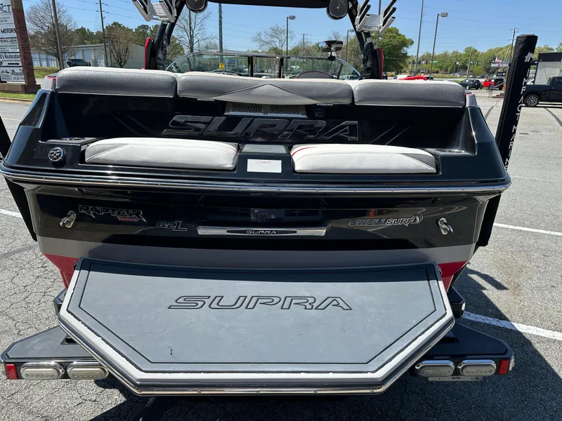 Slide: The Image of 2015 Supra SG400-550 boat, rear view, parked in a lot, showcasing seating and branding. - 17