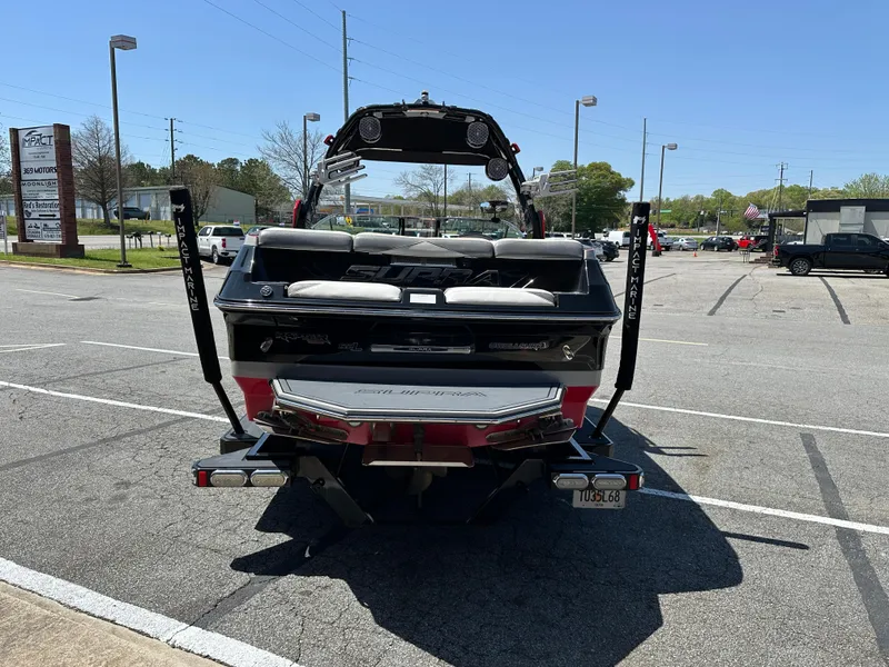Slide: The Image of 2015 Supra SG400-550 boat parked in a lot, rear view. - 2