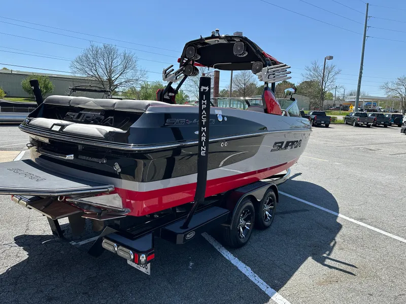Slide: The Image of 2015 Supra SG400-550 boat on trailer in parking lot, rear view. - 4