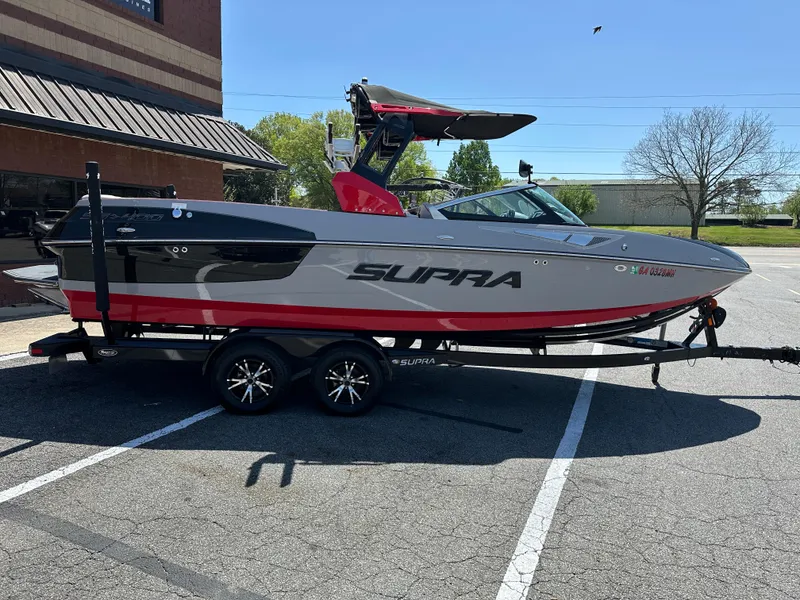 Slide: The Image of 2015 Supra SG400-550 boat on trailer in parking lot, side view. - 5