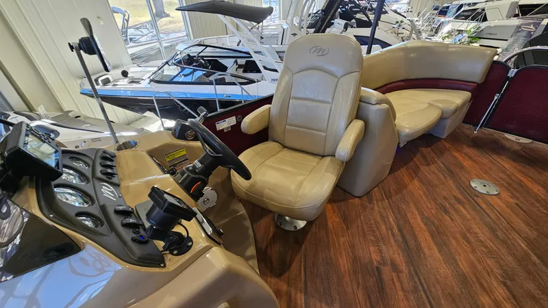 Slide: The Image of 2017 Manitou 25 Aurora LE boat interior with leather seating and wood flooring. - 18