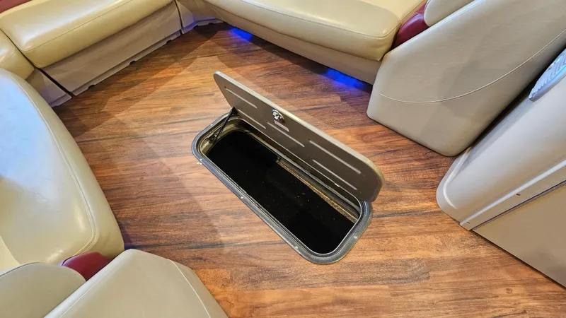 Slide: The Image of 2017 Manitou 25 Aurora LE interior with open floor storage compartment. - 23