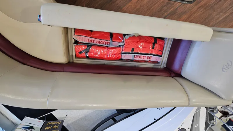Slide: The Image of Storage compartment with life jackets on a 2017 Manitou 25 Aurora LE boat. - 24