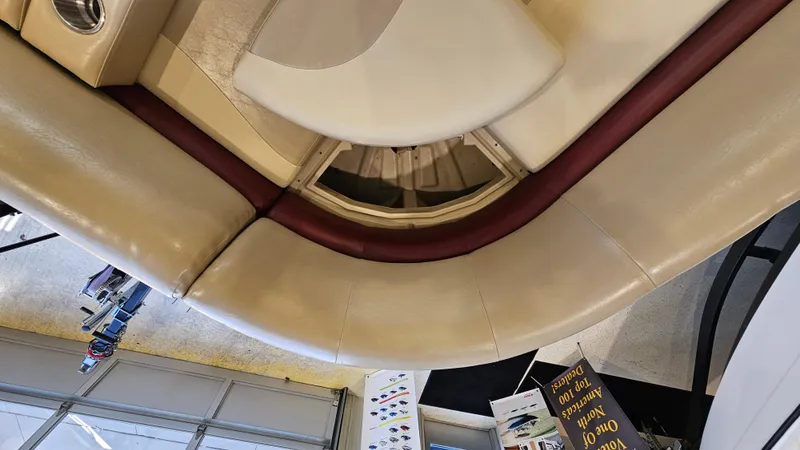 Slide: The Image of 2017 Manitou 25 Aurora LE boat interior with beige and maroon seating. - 25