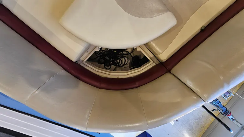 Slide: The Image of 2017 Manitou 25 Aurora LE boat interior with beige and maroon seating. - 26