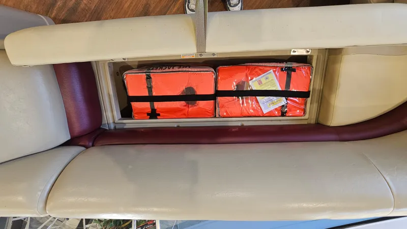 Slide: The Image of Storage compartment with life jackets in a 2017 Manitou 25 Aurora LE boat. - 27