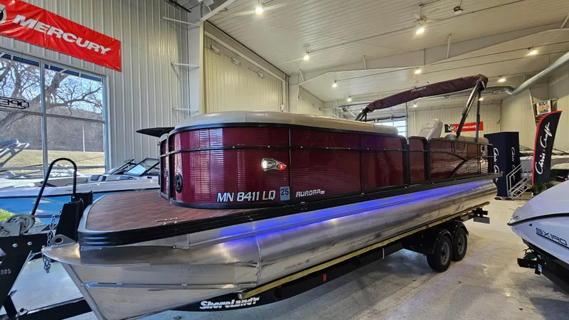 Slide: The Image of 2017 Manitou 25 Aurora LE pontoon boat displayed indoors. - 3