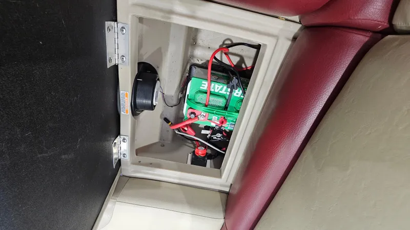 Slide: The Image of Battery compartment of 2017 Manitou 25 Aurora LE with red and black wiring. - 30