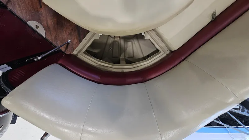 Slide: The Image of 2017 Manitou 25 Aurora LE boat interior with beige and maroon seating. - 31