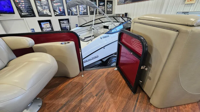 Slide: The Image of 2017 Manitou 25 Aurora LE interior with beige seating and wood flooring. - 32