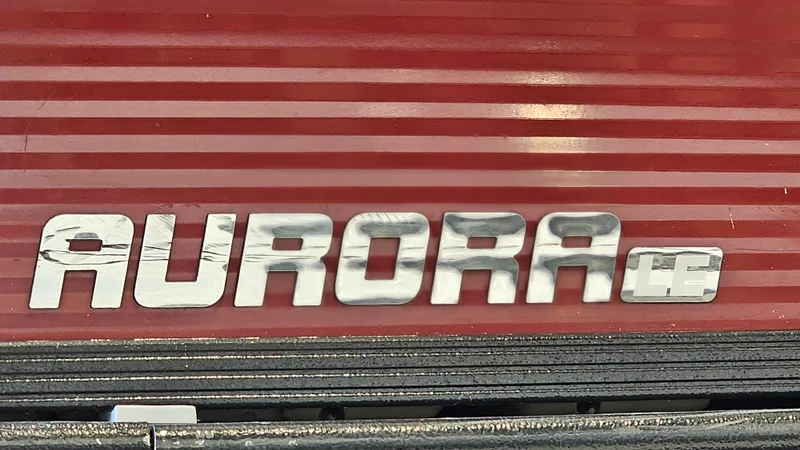 Slide: The Image of 2017 Manitou 25 Aurora LE logo on red background. - 35