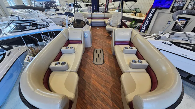 Slide: The Image of 2017 Manitou 25 Aurora LE pontoon boat interior with luxurious seating and wood-style flooring. - 8
