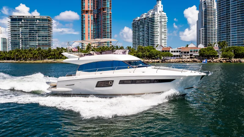 The Image of 2017 Prestige 500 yacht cruising near modern city skyline. - 12