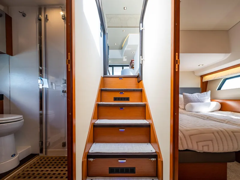 Slide: The Image of Interior of 2017 Prestige 500 yacht showing stairs, bedroom, and bathroom. - 27