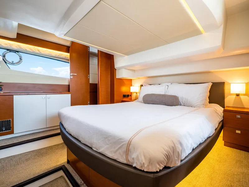 Slide: The Image of Luxurious bedroom interior of a 2017 Prestige 500 yacht, featuring a cozy bed and elegant lighting. - 31