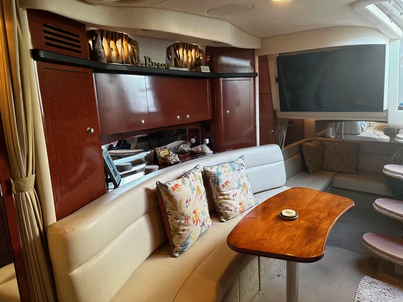 Slide: The Image of Luxurious interior of 2005 Sea Ray 340 Sundancer yacht with plush seating and wooden table. - 18