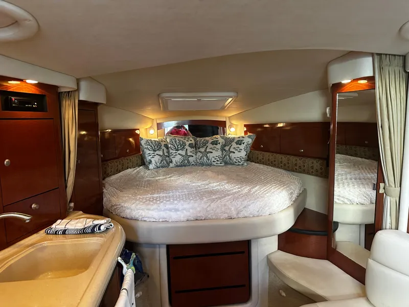 Slide: The Image of Luxurious 2005 Sea Ray 340 Sundancer cabin with cozy bed and elegant wood finishes. - 22
