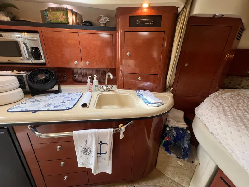 Slide: The Image of Interior of a 2005 Sea Ray 340 Sundancer yacht with kitchenette and bed. - 25