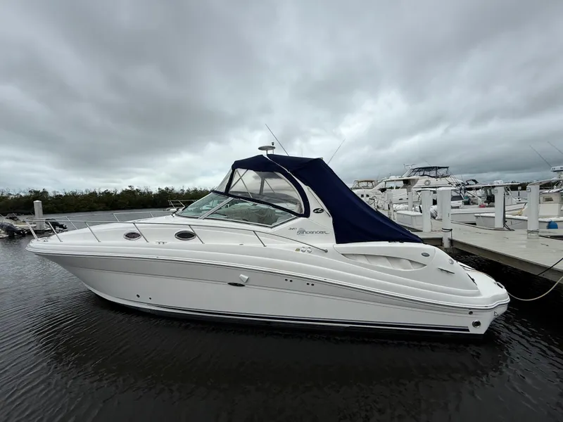Slide: The Image of 2005 Sea Ray 340 Sundancer yacht docked under cloudy skies. - 4