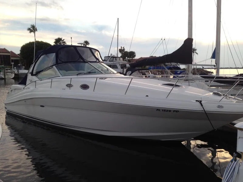 Slide: The Image of 2005 Sea Ray 340 Sundancer docked at marina, sleek design, calm water. - 5