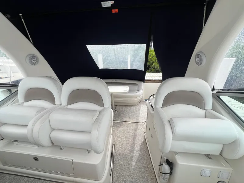 Slide: The Image of 2005 Sea Ray 340 Sundancer interior with plush white seating and modern design. - 8