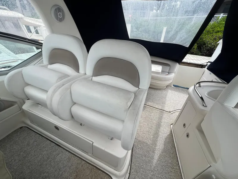 Slide: The Image of Interior seating of 2005 Sea Ray 340 Sundancer boat, featuring plush white upholstery. - 9
