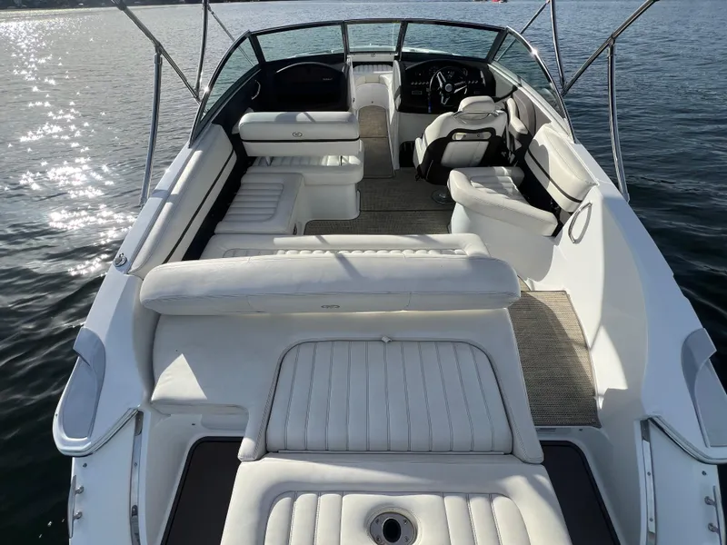 Slide: The Image of 2015 Cobalt R3 boat interior with white seating, steering wheel, and sunlit water backdrop. - 12