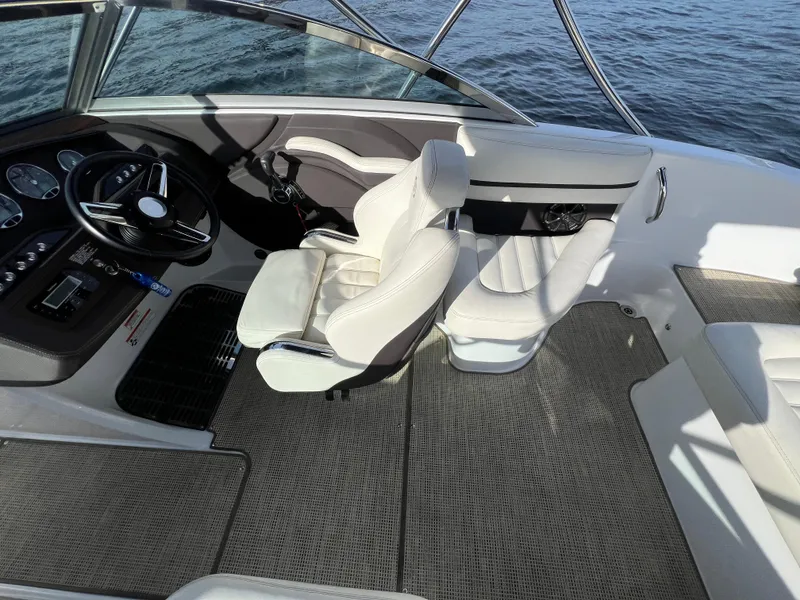 Slide: The Image of Interior of a 2015 Cobalt R3 boat with white seating and steering wheel. - 15