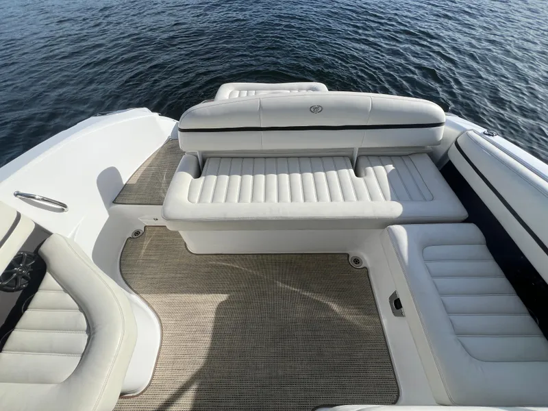 Slide: The Image of 2015 Cobalt R3 boat interior with white leather seating, on calm water. - 16