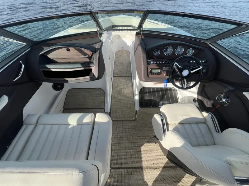 Slide: The Image of Interior of a 2015 Cobalt R3 boat with steering wheel and seating. - 17