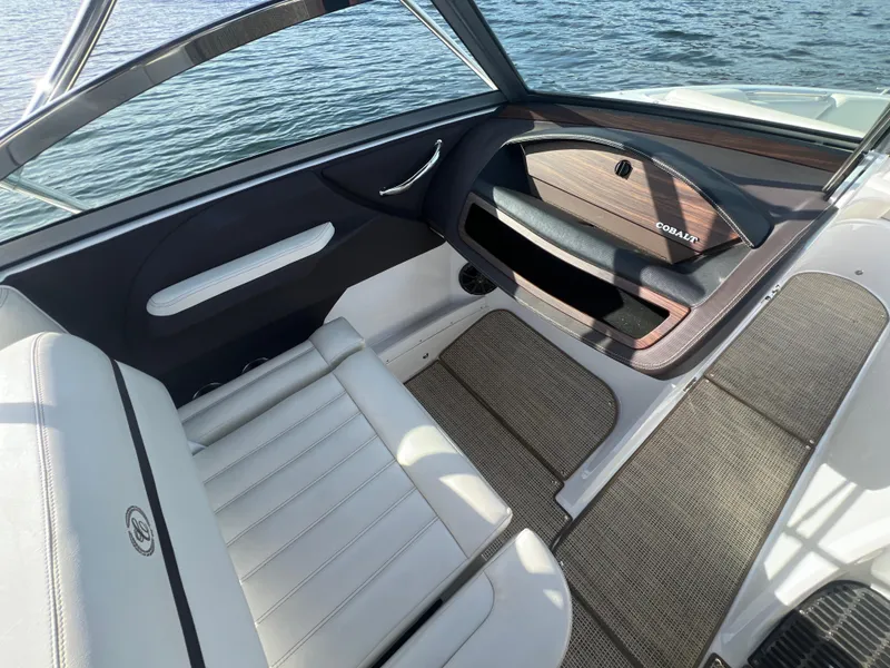 Slide: The Image of Interior of a 2015 Cobalt R3 boat with white seating and wood accents. - 18
