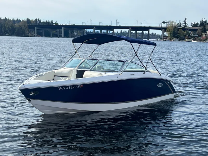 Slide: The Image of 2015 Cobalt R3 boat on a lake with a bridge in the background. - 2